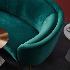 Elegant emerald green velvet couch with sleek metallic legs, ideal for luxurious living spaces