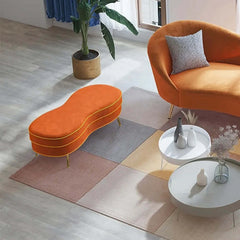 Chic orange velvet ottoman bench with gleaming gold legs