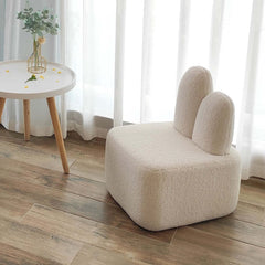 Beige upholstered modern accent chair with rabbit design