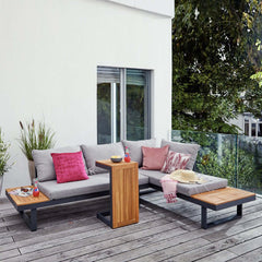 Outdoor sectional sofa with cushioned back and side table for cozy outdoor seating