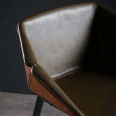 Stylish faux leather upholstered bar chair with black metal frame for contemporary homes