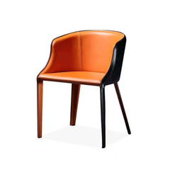 Elegant modern saddle chair in black and orange leather with sturdy metal legs for dining room