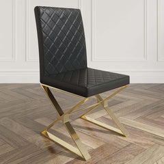 Two modern black leather dining chairs with gold legs - sleek and sophisticated seating option