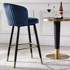 Elegant blue counter stool with tufted upholstery and footrest