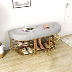 Modern upholstered entryway bench in gray with gold accents and shelf for added storage