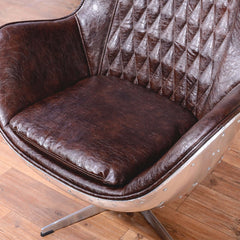 Elegant brown & silver office chair upholstered in luxurious leather with swivel and wing back features