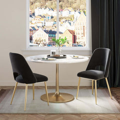 Sleek modern upholstered dining chairs in black with hollow back and shiny gold legs